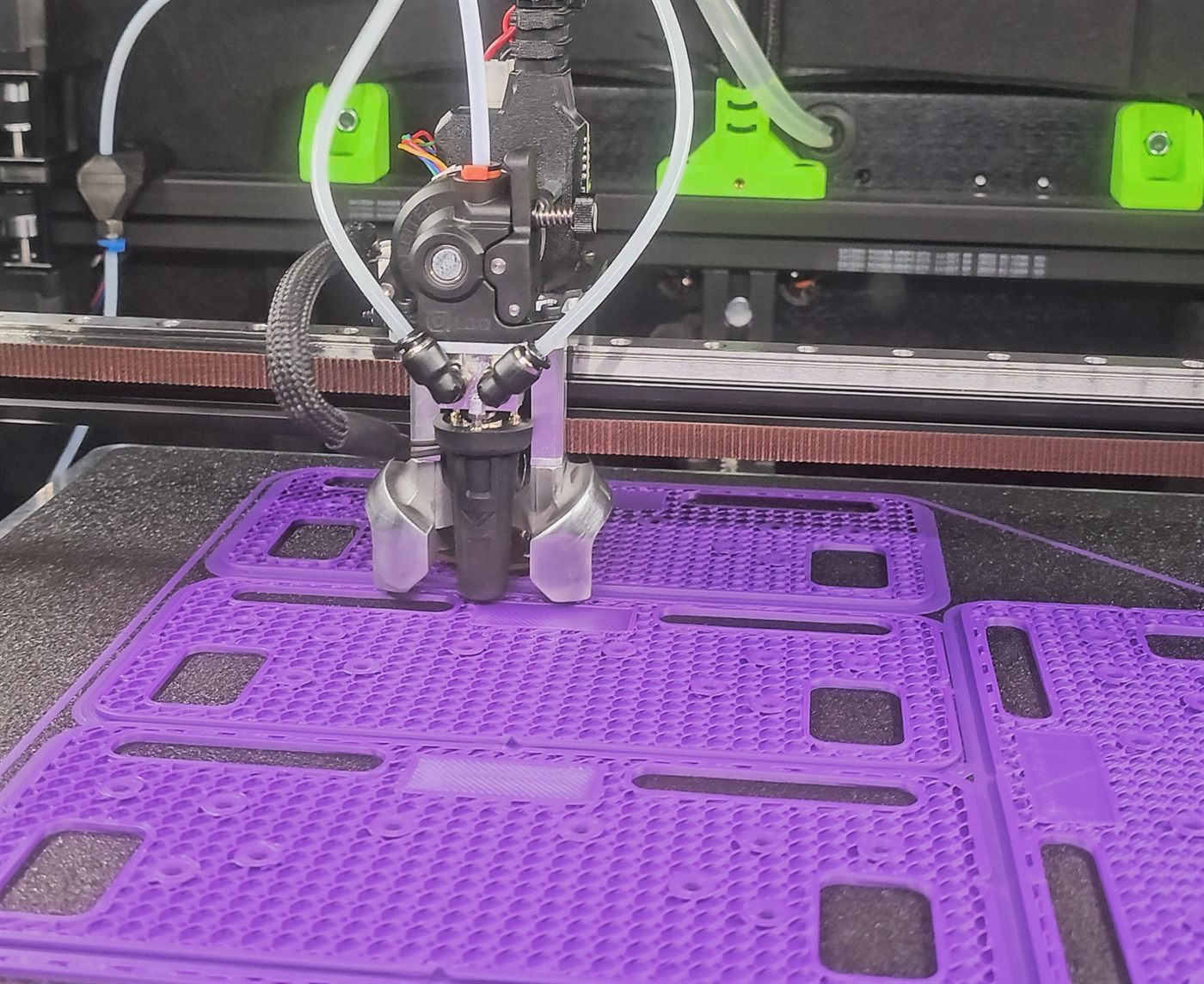 The jigs being printed, nozzle laying down the pattern