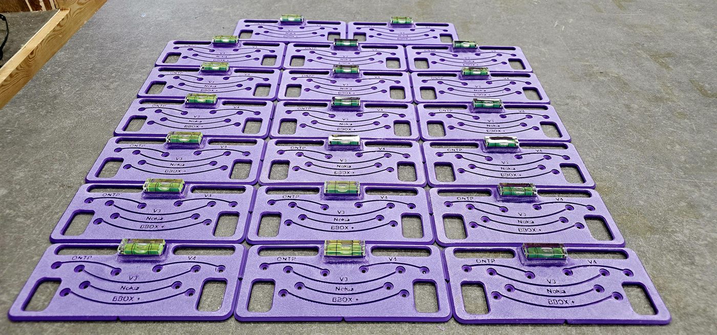 The full batch of installation jigs, each with a built-in spirit level