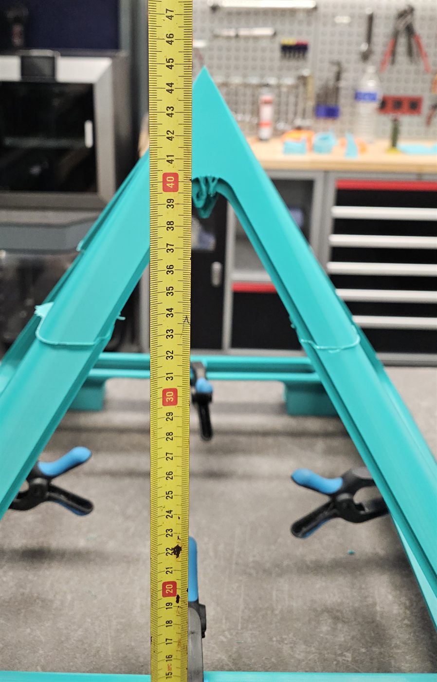 The frame of that build in progress, printed in sections and bonded, a tape measure showing its size
